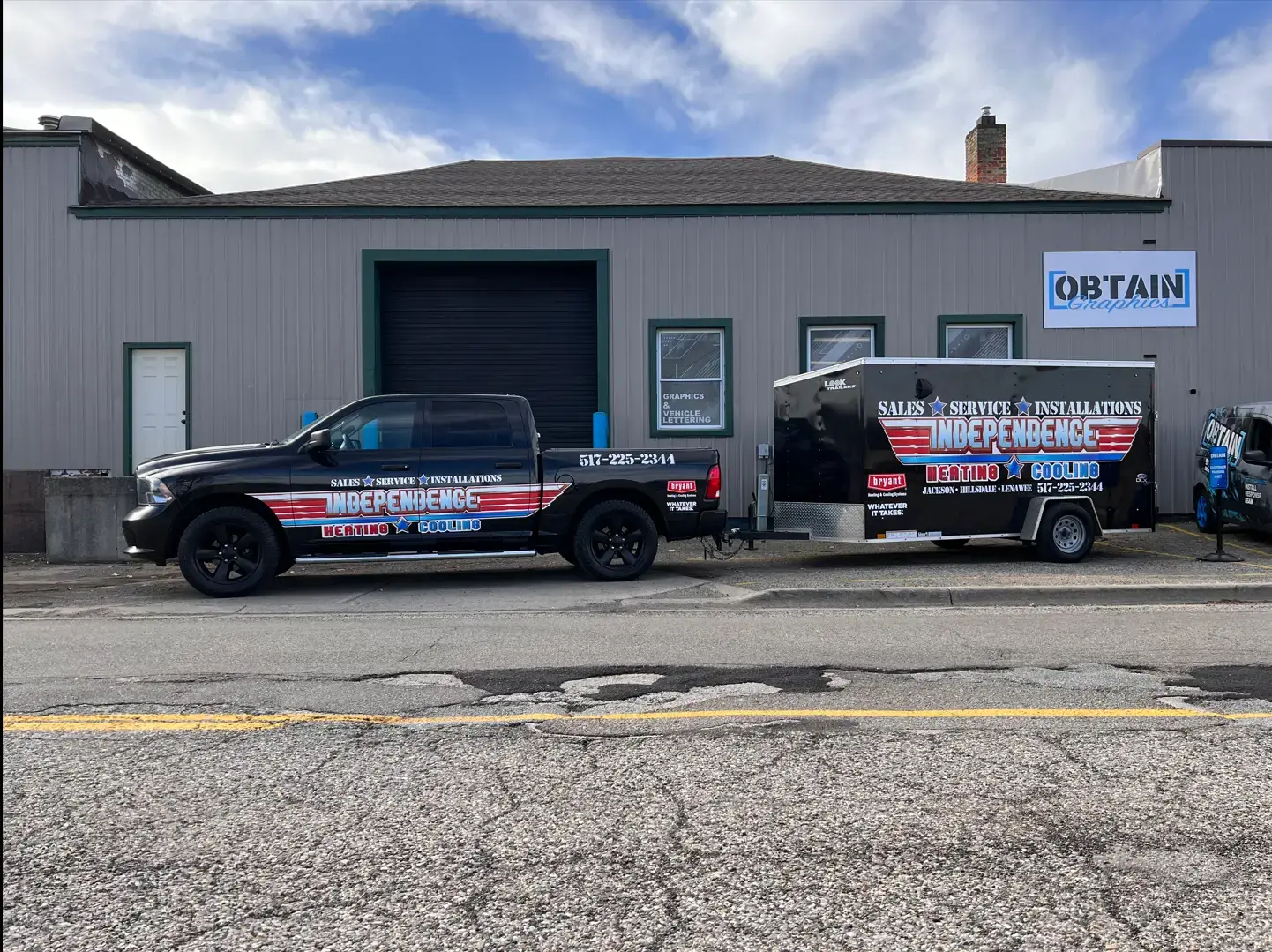 Truck and trailer parked outside a building.