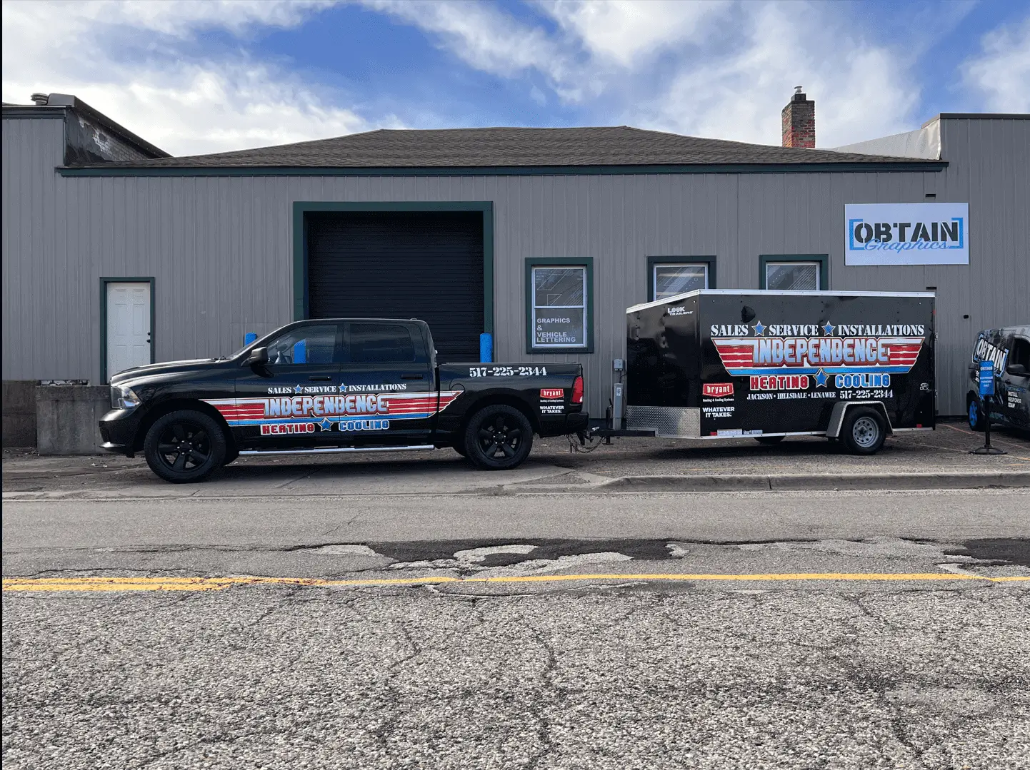 Truck and trailer parked outside a building